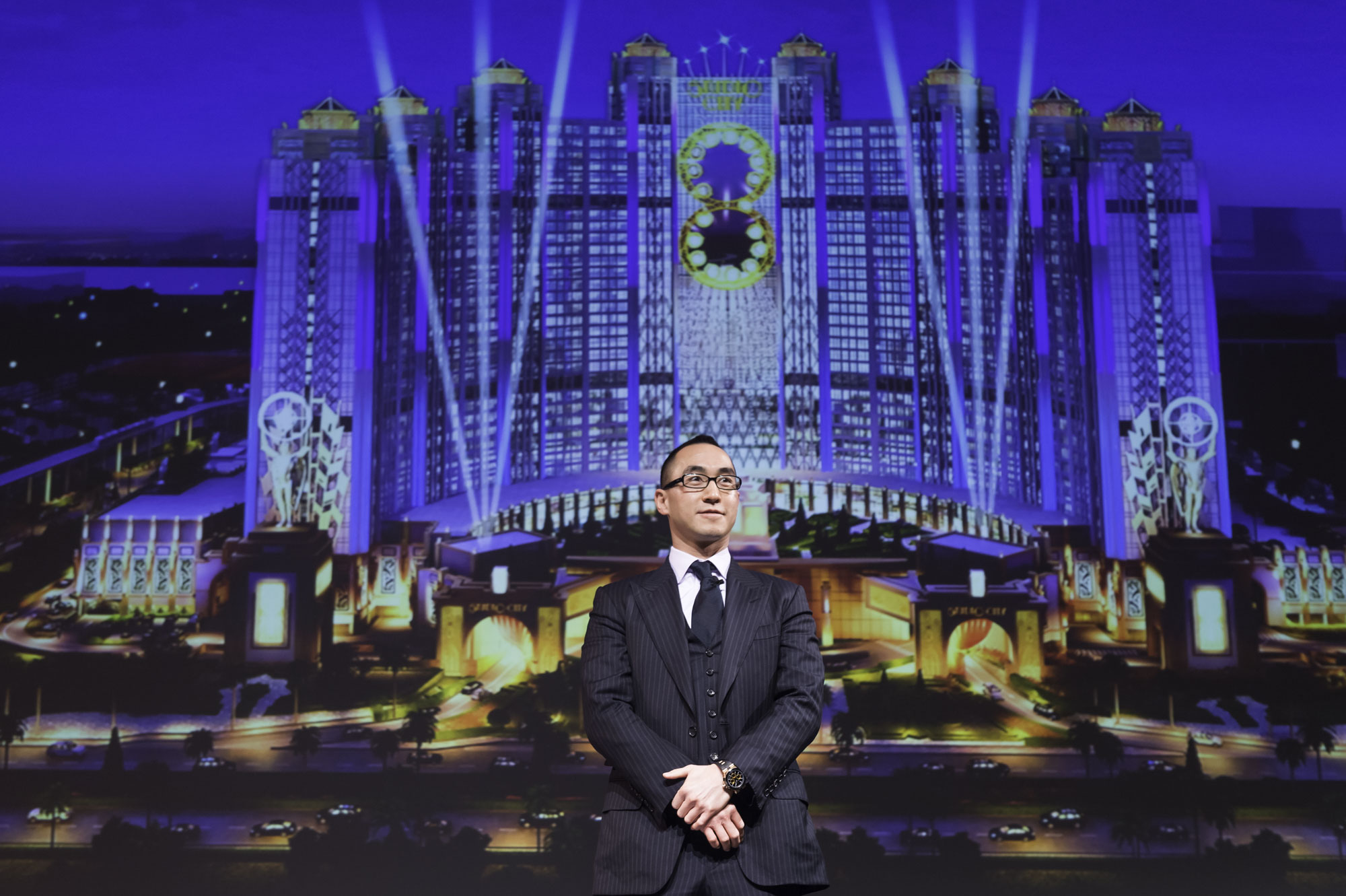 Lawrence Ho in front of artist rendition of Studio City in Cotai, Macau
